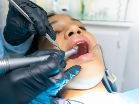 Dentist cleaning a patient’s teeth